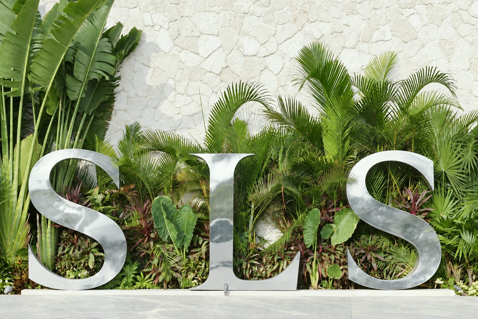 SLS Playa Mujeres tropical garden wall and sculptural hotel sign