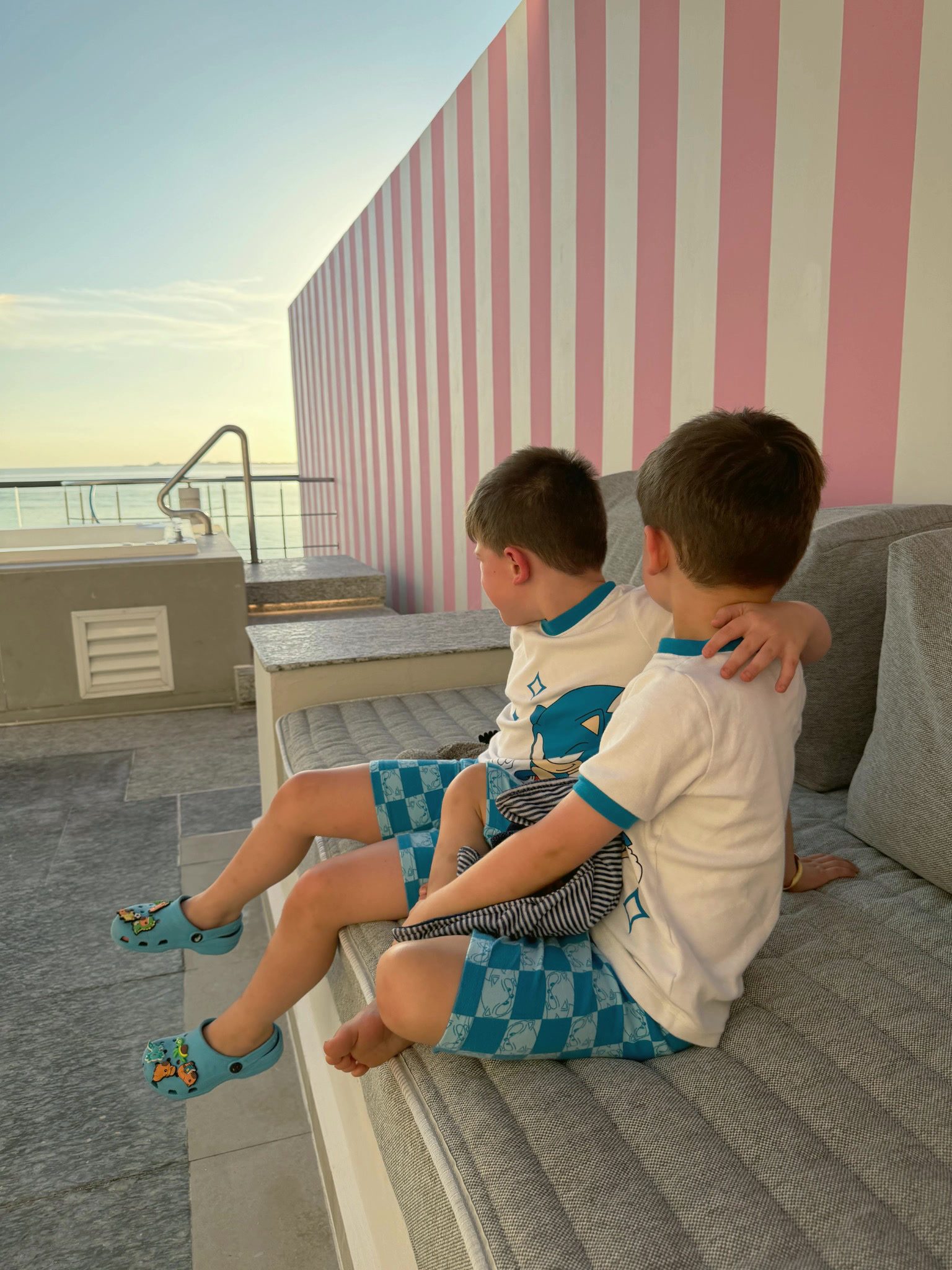 Two children sitting together at SLS Playa Mujeres