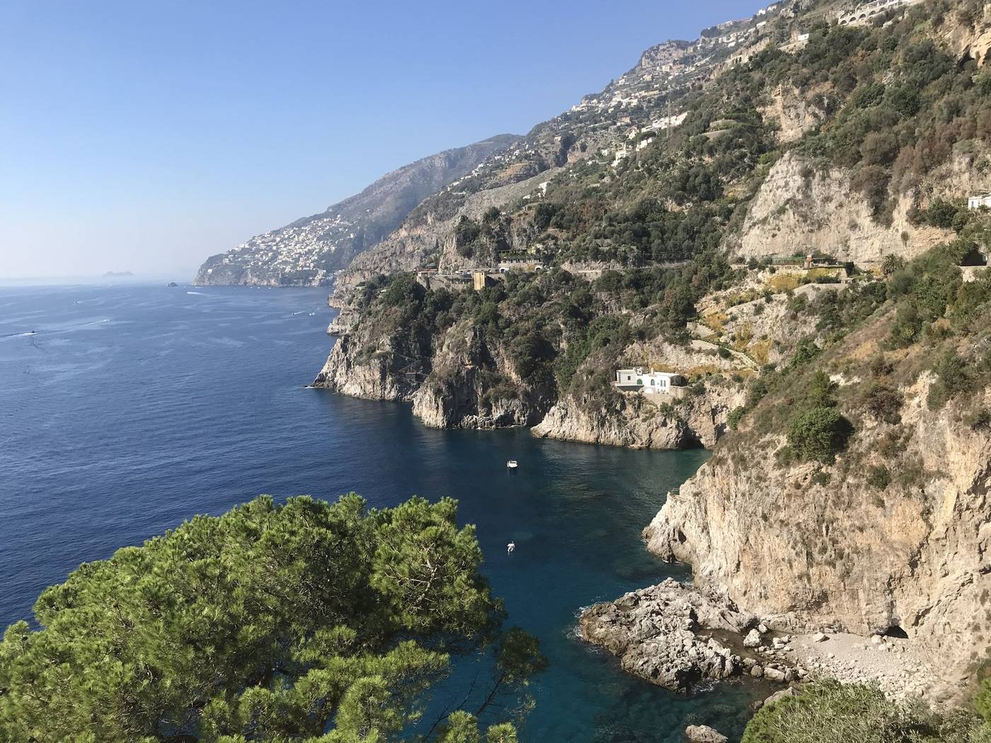 Dramatic cliffs and deep blue water along a Mediterranean coastline